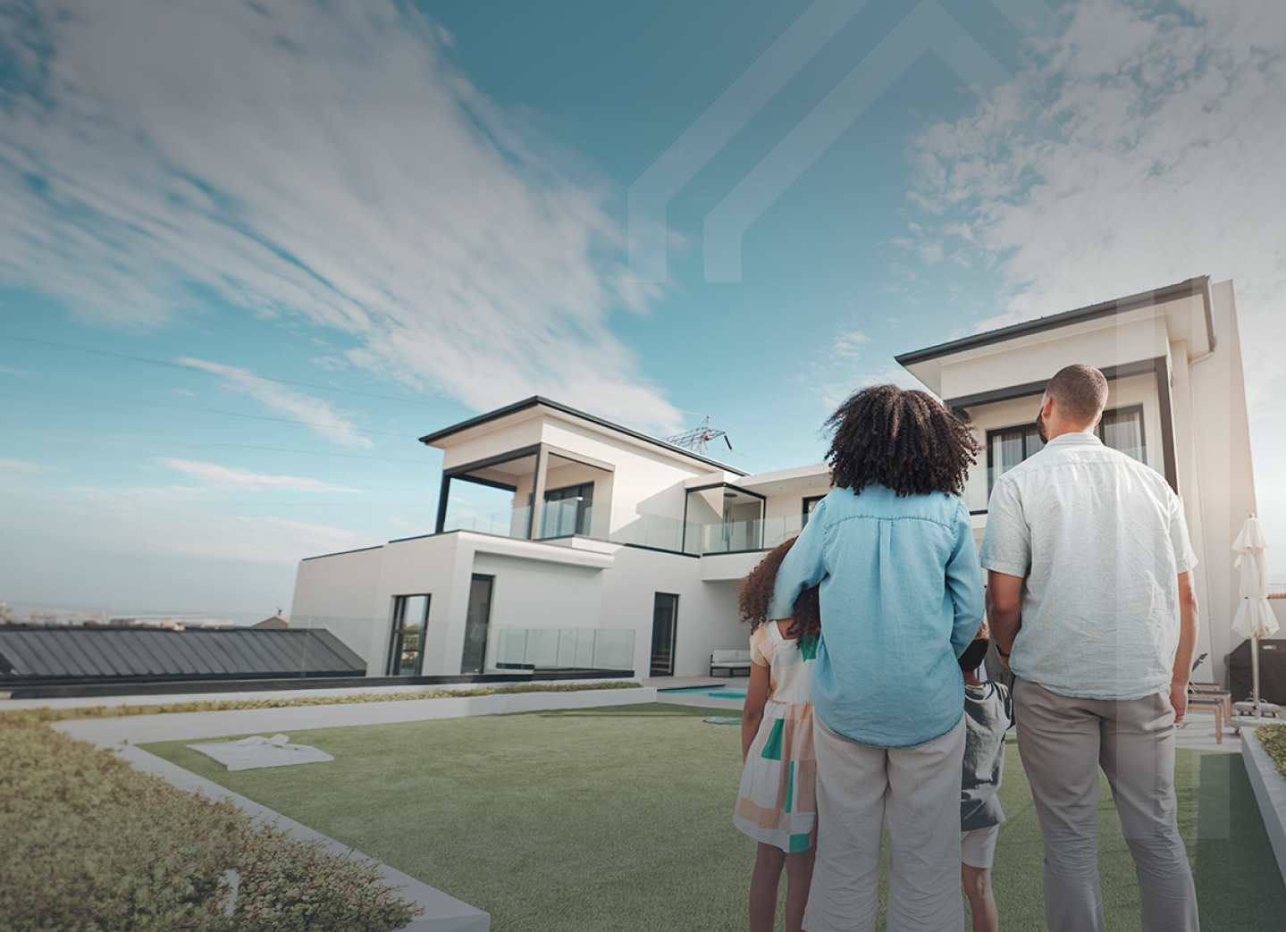 A family standing in front of a house.