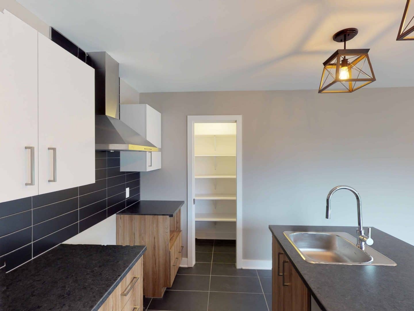 Semi-detached / bi-generation one-storey prefabricated house of the Magistral model in contemporary style. Interior kitchen view.