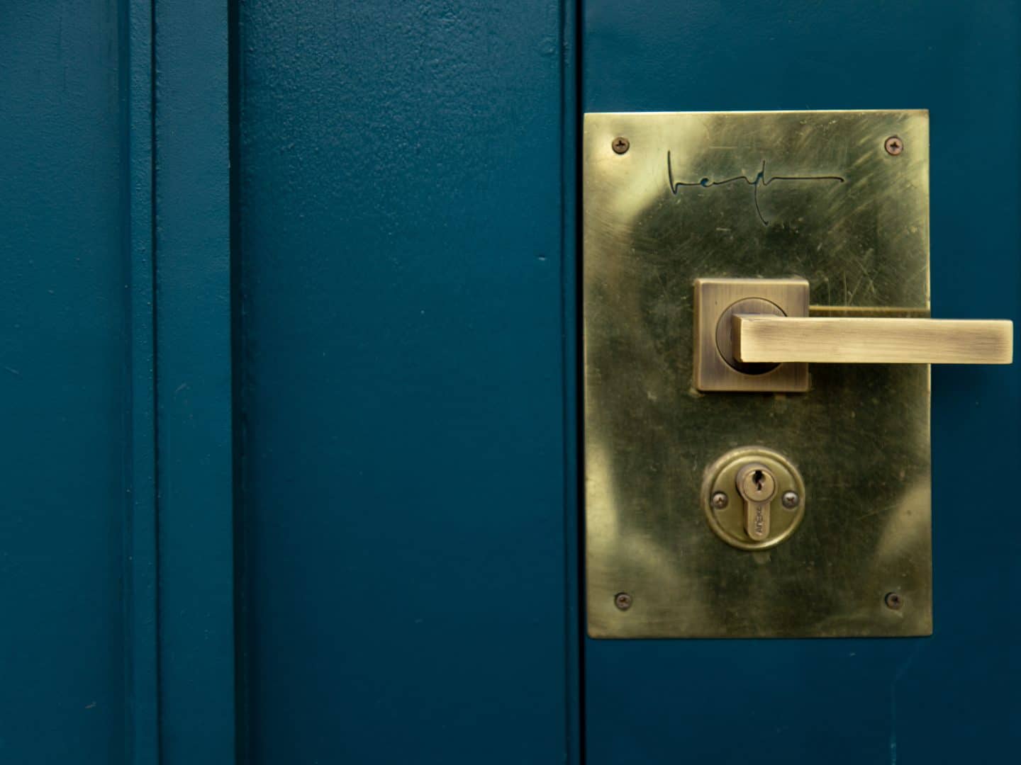 Blue door with a closed lock.