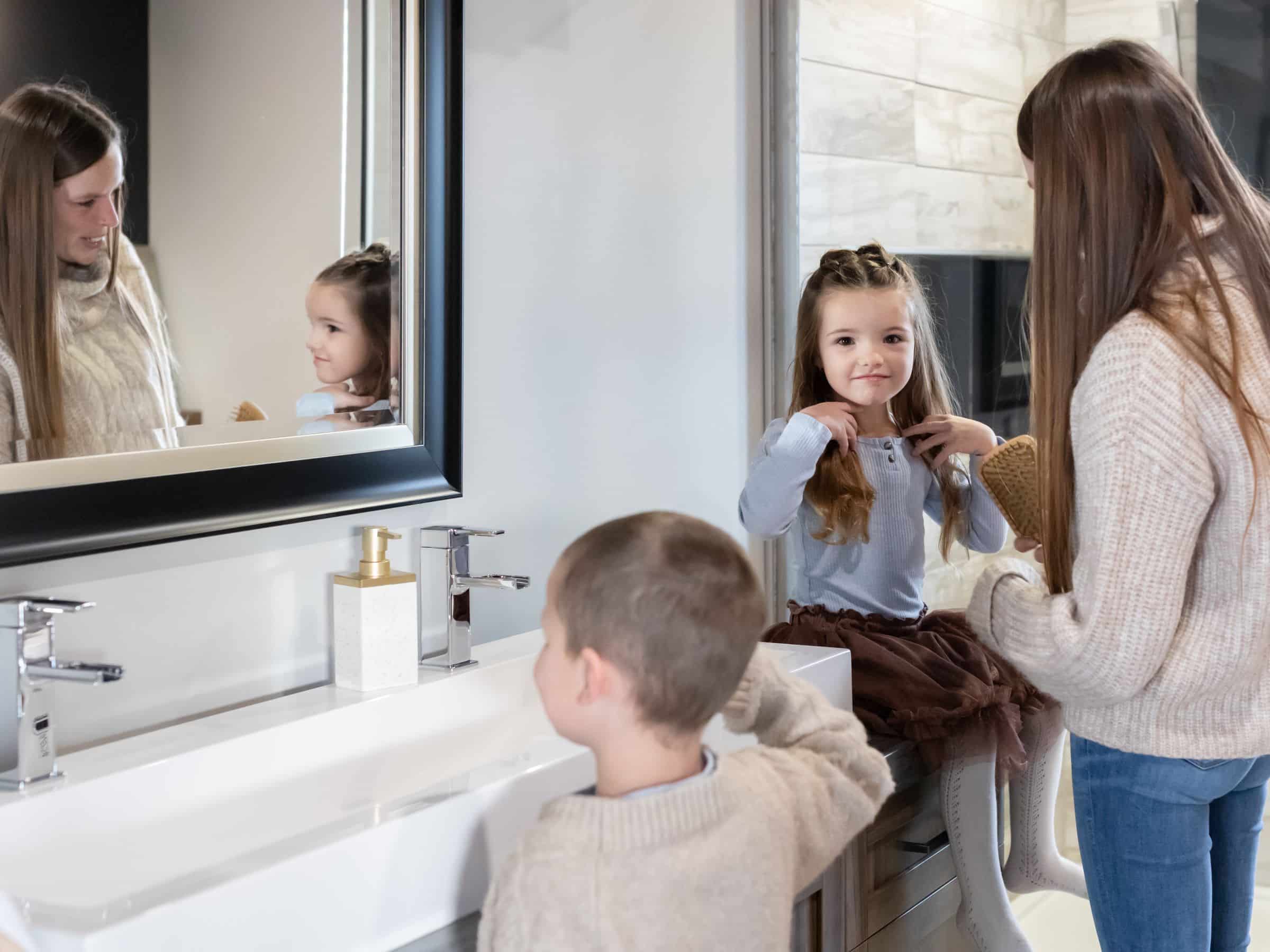 A family in the bathroom, getting ready.
