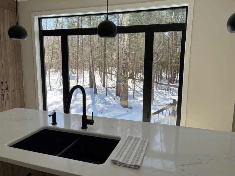 A ProFab home realization of a prestigious custom-built contemporary farmhouse style bungalow. View from the kitchen.