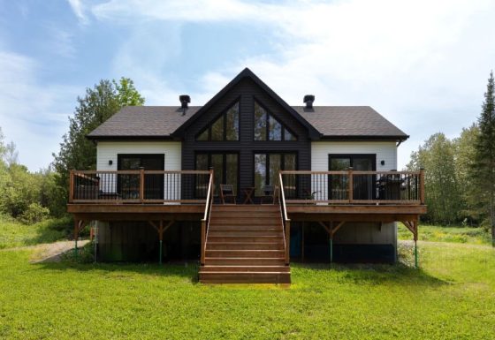 Une réalisation d'une maison préfabriquée appelée Merle. Cette réalisation client est de style Chalet contemporain, vu du salon.